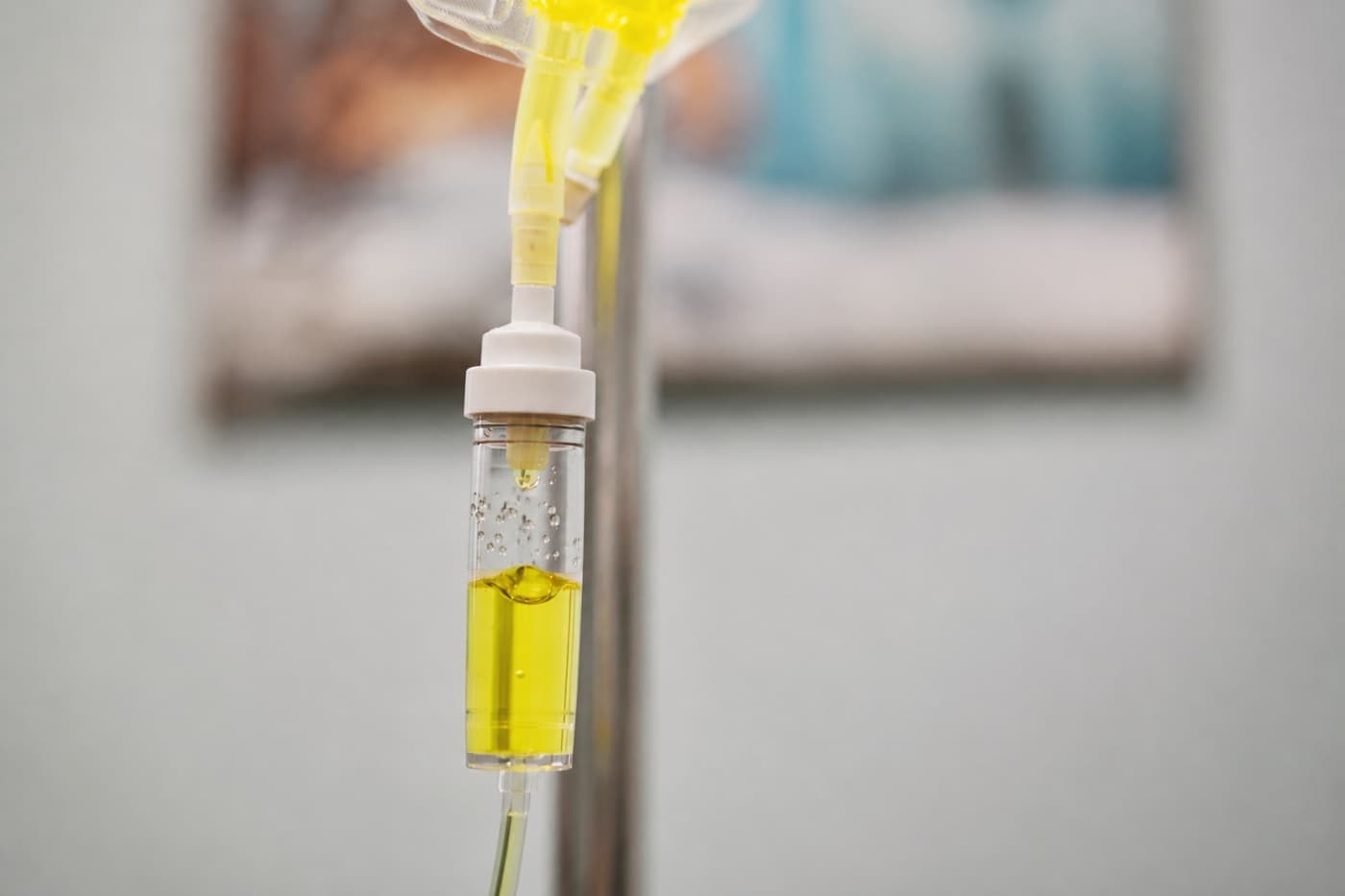A vitamin IV drip chamber running on a stand in a treatment room at Solis Medical Clinic in Edmonton.